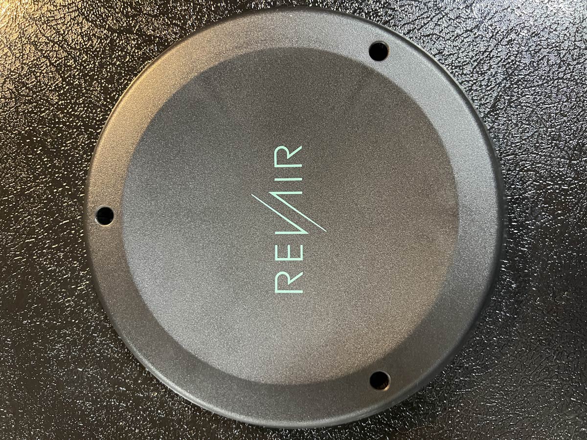 black injection molded circular pad-printed part with revair printed in green