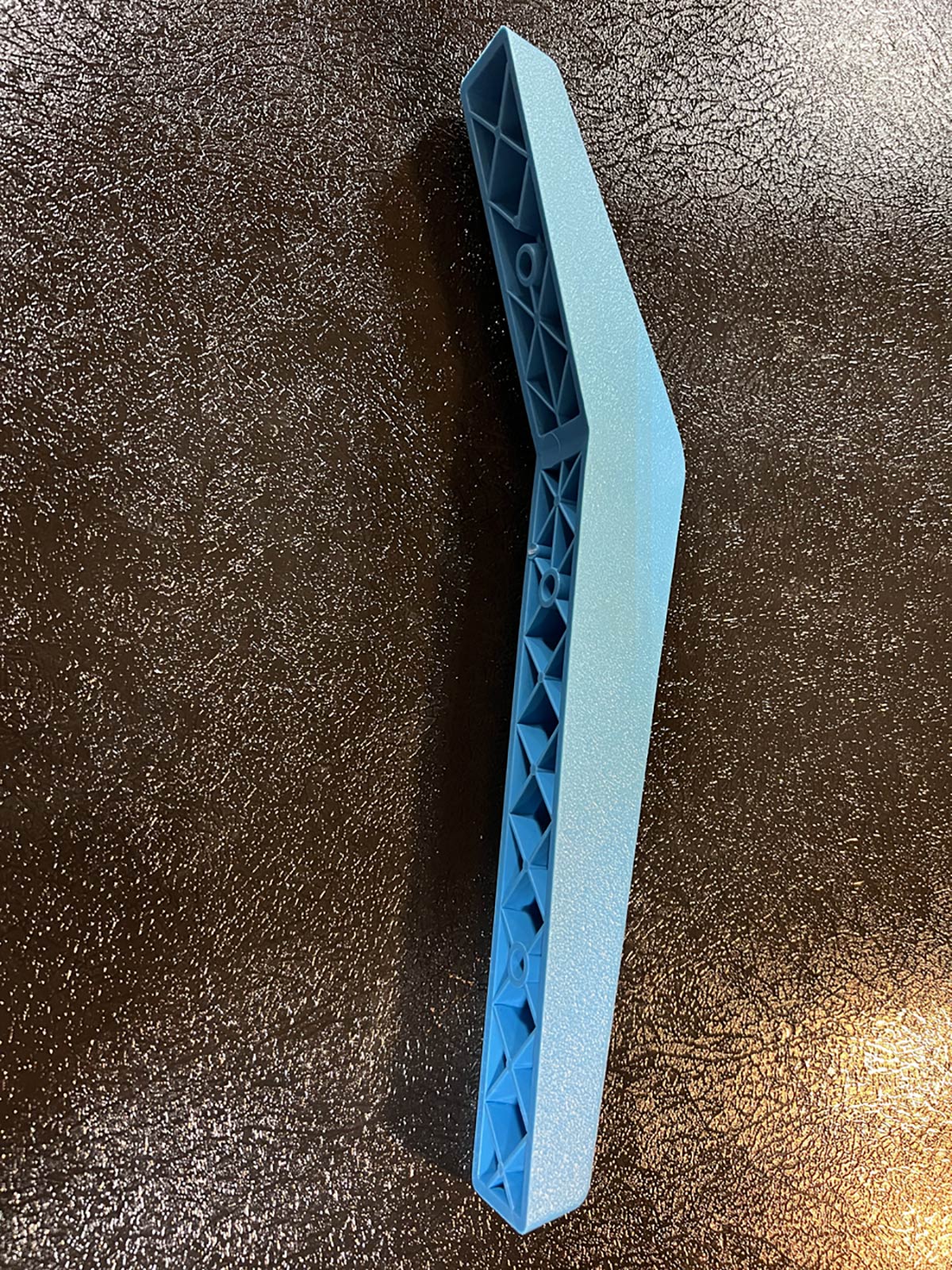 blue injection molded structurally ribbed bracket for a adirondack chair assembly