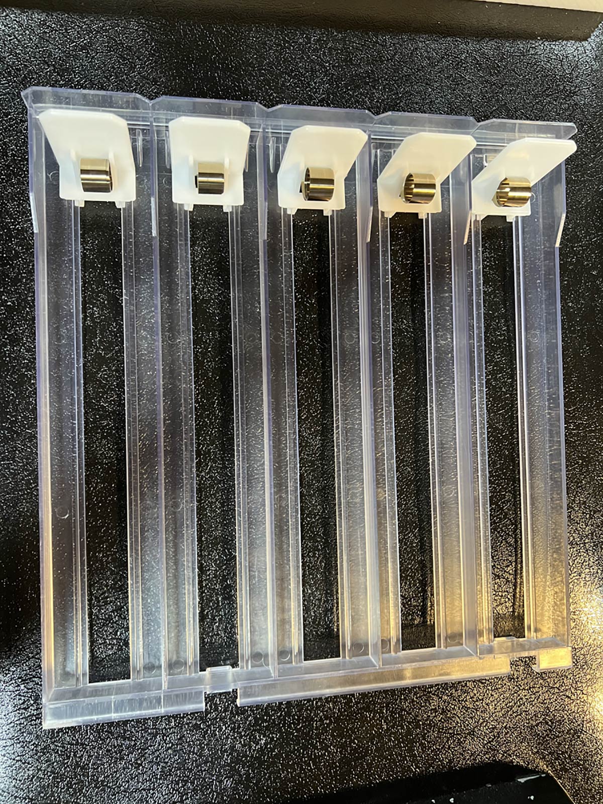 5-slot assembly made with injection molded parts to hold cigarette packs
